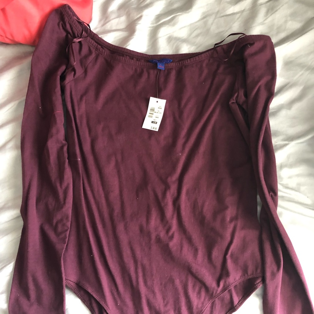 Plum long sleeved body suit.